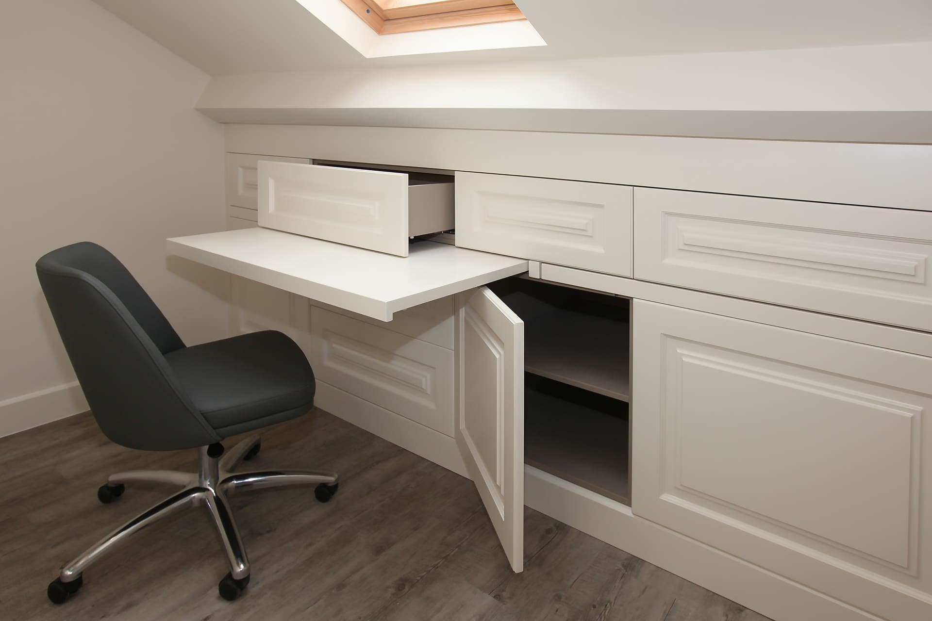 Open drawer in a panelled cabinet under the roof