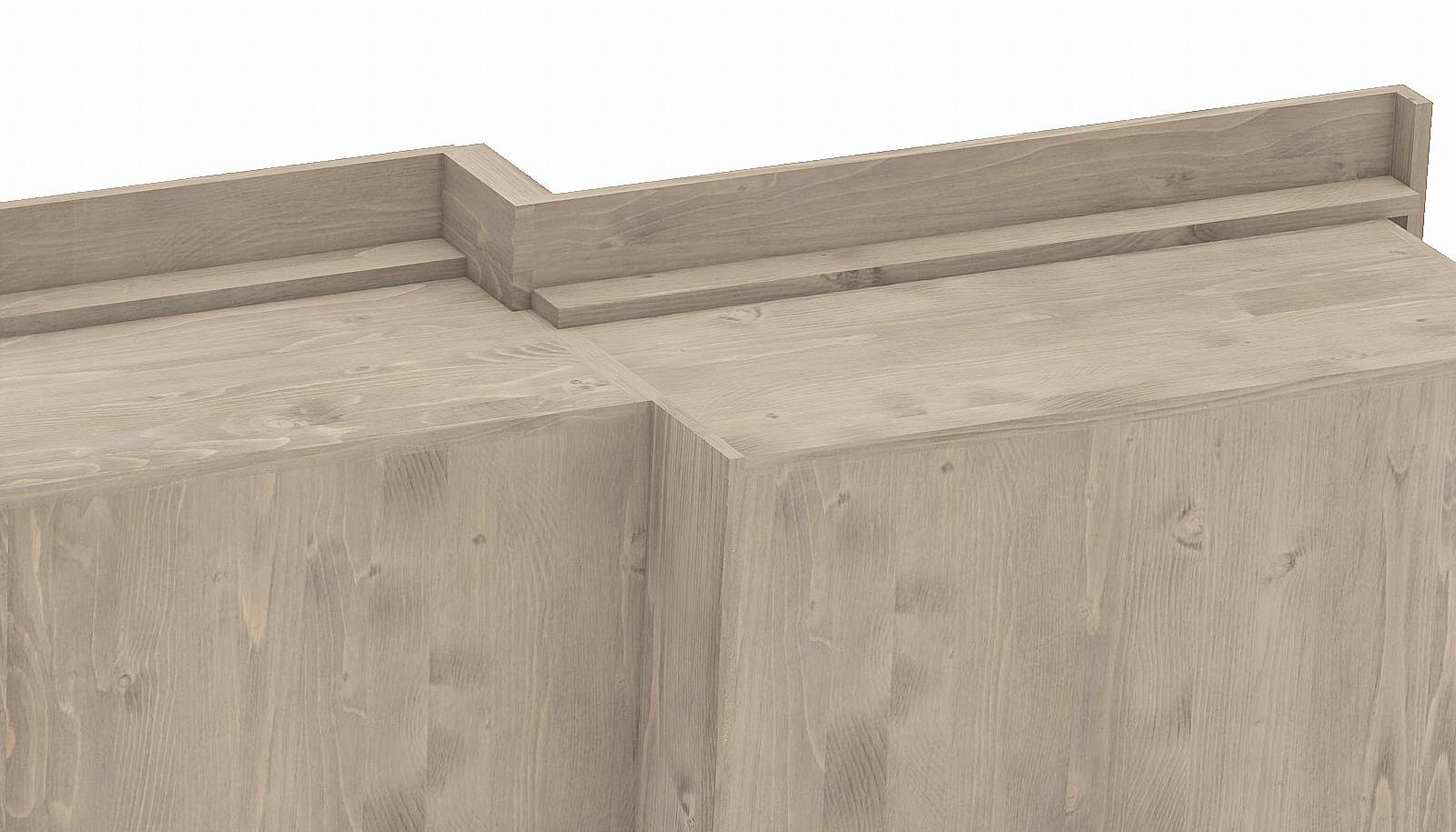 A detail of the cornice and the top edge of the cabinet.
