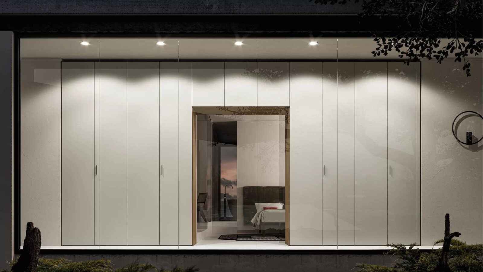 A white handleless cabinet wall with a mirrored niche in the middle.
